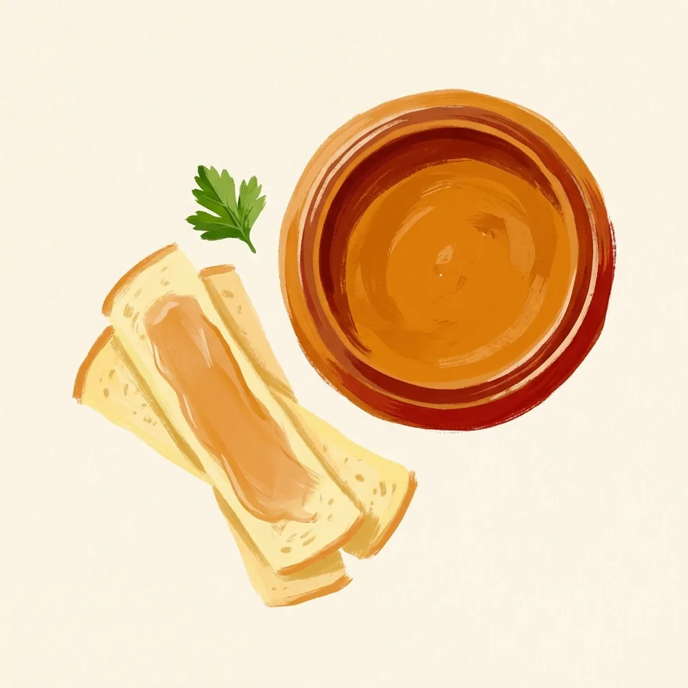 Illustration von oben: eine Schale mit cremiger Erdnussbutter und daneben weiche Brotstreifen, auf die eine dünne Schicht davon gestrichen ist. Keine ganzen Nüsse.